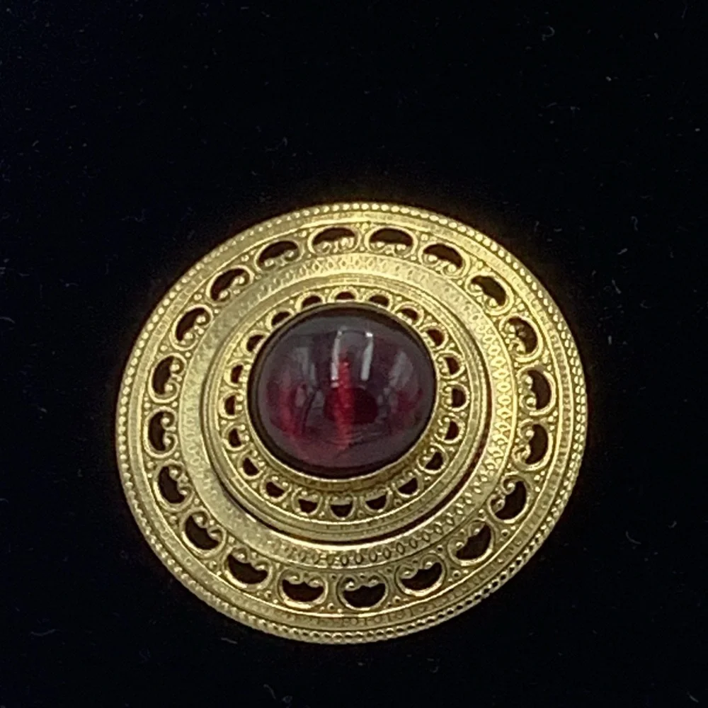 Gold Tone Round Filigree Brooch with Red/Purple Stone